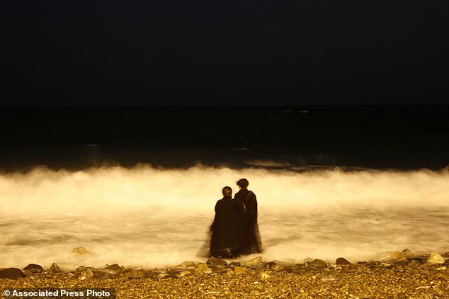 Two veiled Saudi women enjoy the Red Sea at night. The Red Sea project will be built along 125 miles (200 kilometers) of coastline and is tailored toward global luxury travelers