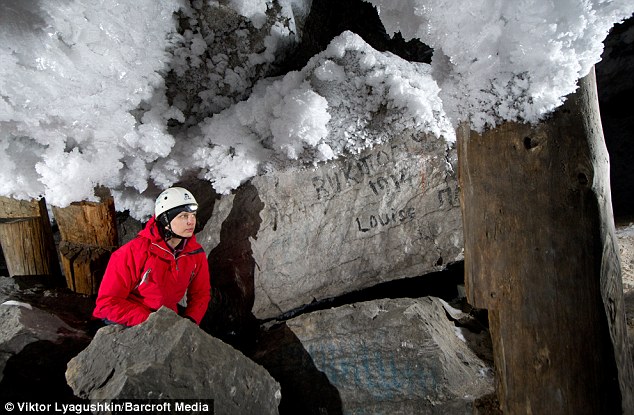 Graffitti is scrawled onto rocks close to where ice is forming on the cave roof of the Kungur caves