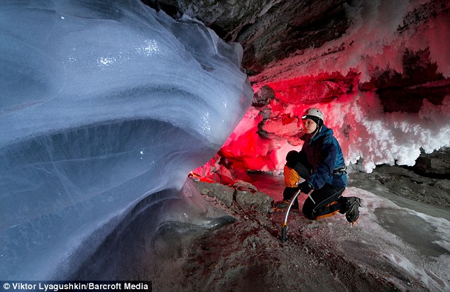Big freeze: A caver stands next to a build up of ice in the Kungur Ice Caves in Kungur, Russia