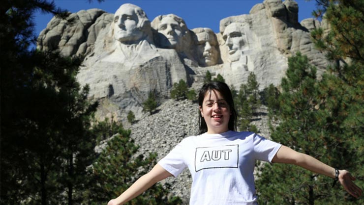 A woman stands in front of Mount Rushmore in North Dakota