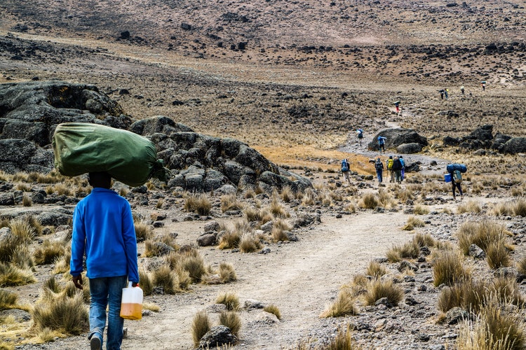 Porter carries a load along one of the routes to Kilimanjaro